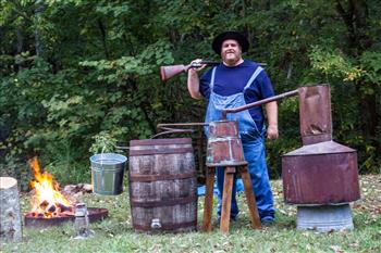 Brad Halfacre, son of the Edgar Evins State Park manager and a ranger at Henry Horton State Park, is a crowd-pleaser in his role as a local moonshiner.