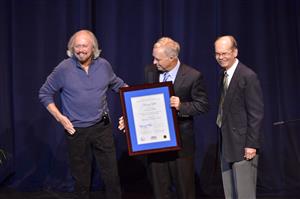 Barry Gibb is presented with the Inaugural Fellowship of the Center for Popular Music at MTSU by Ken Paulson (center), Dean of the College of Mass Communications, and Dr. Dale Cockrell (right), Director of the Center for Popular Music. (MTSU photo by Andy Heidt)