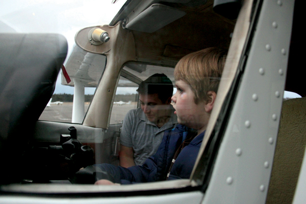 Pilot Victor Huey (left) with a curious 5-year-old co-pilot. 