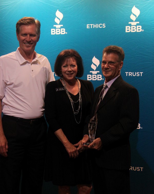 Ken Moore, chairman of the BBB of Middle Tennessee (and the general manager at Beaman Dodge, Jeep, Chrysler) and Terrie Page, BBB branch manager,  congratulate Young on his 2016 award.